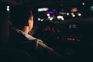 young man driving his car night time